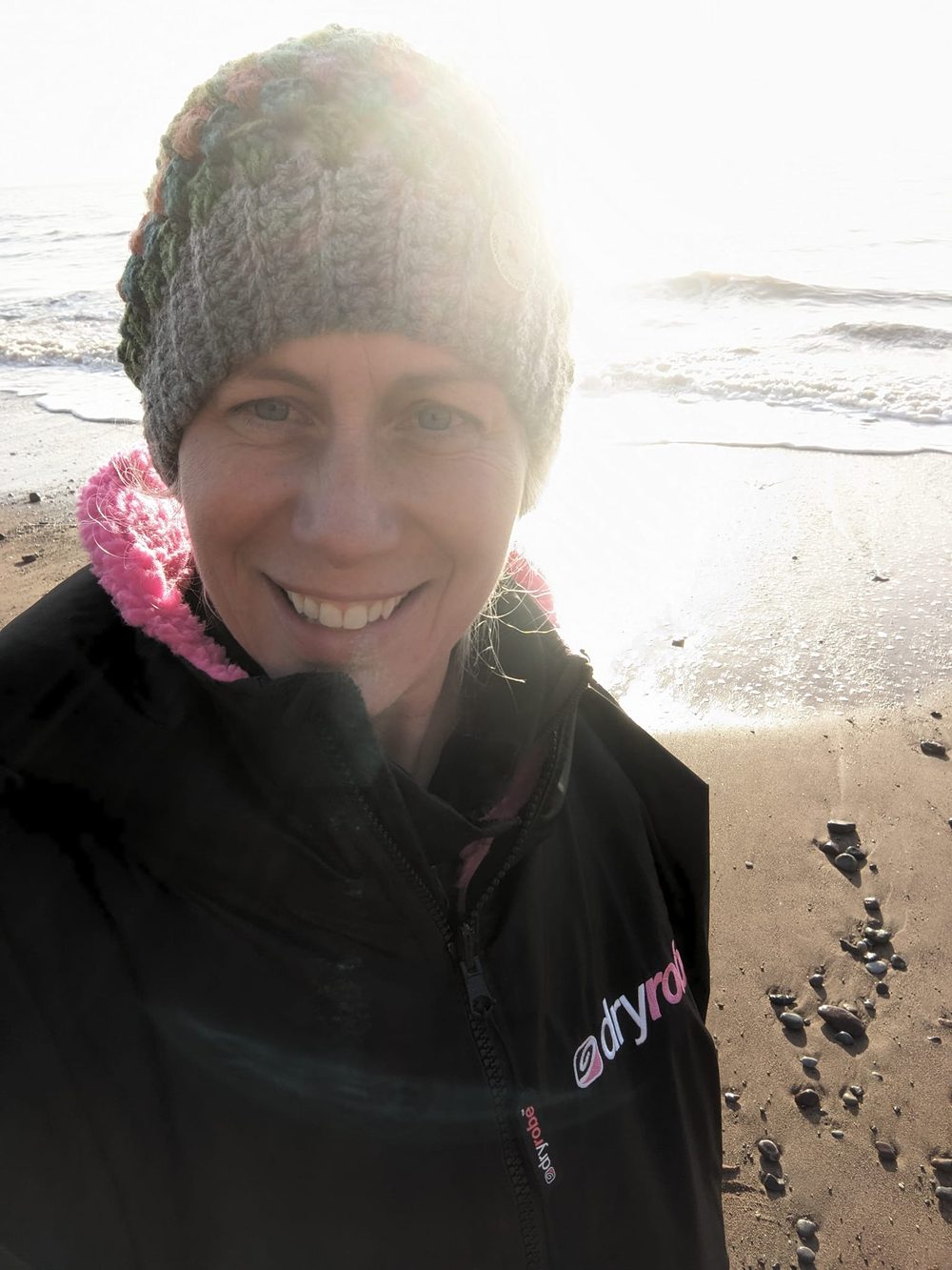 After a winter swim, sun behind the waves